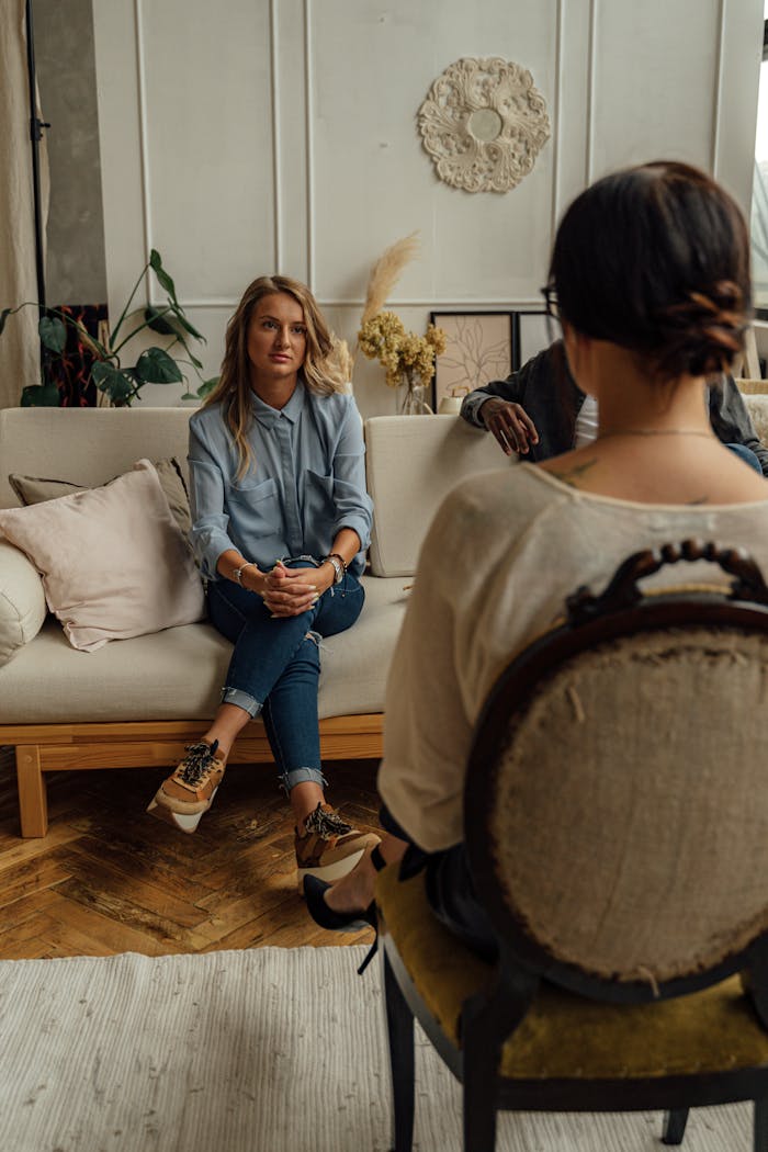 Home A therapist and client in discussion during a cozy indoor session highlighting mental health.